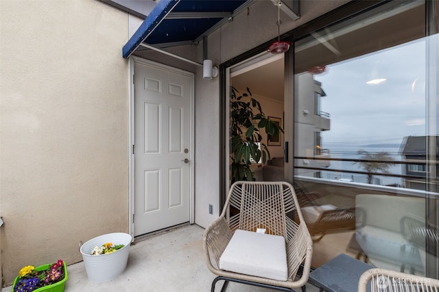 doorway to property featuring a balcony and stucco siding