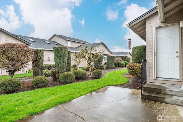 view of side of home featuring a lawn