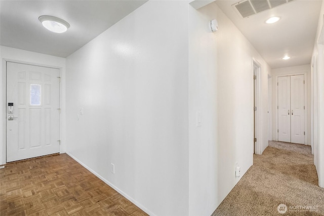 foyer with recessed lighting, visible vents, and baseboards