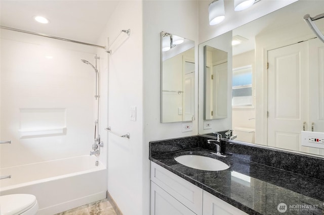 full bathroom featuring baseboards, vanity, toilet, and shower / bathtub combination