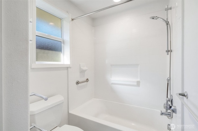 bathroom featuring shower / bath combination and toilet