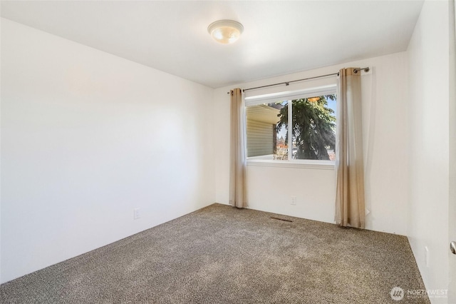 unfurnished room with carpet and visible vents