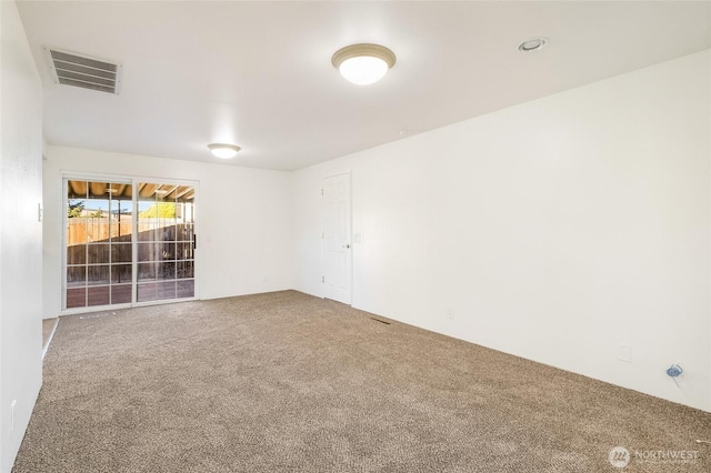 carpeted empty room with visible vents