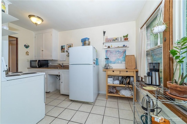 kitchen featuring light tile patterned floors, white appliances, and white cabinetry