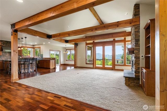 unfurnished living room with baseboards, dark wood finished floors, vaulted ceiling with beams, french doors, and recessed lighting