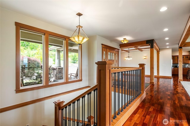 corridor with recessed lighting, baseboards, dark wood finished floors, and an upstairs landing