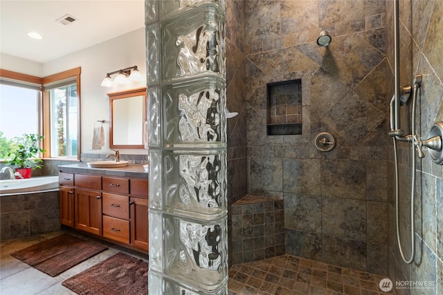 full bathroom featuring visible vents, walk in shower, vanity, and a bath