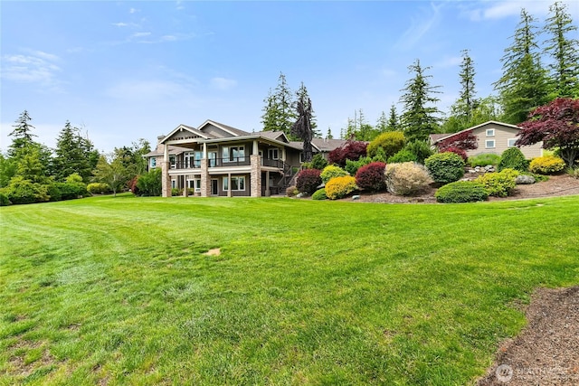 view of front of property with a front yard and stone siding