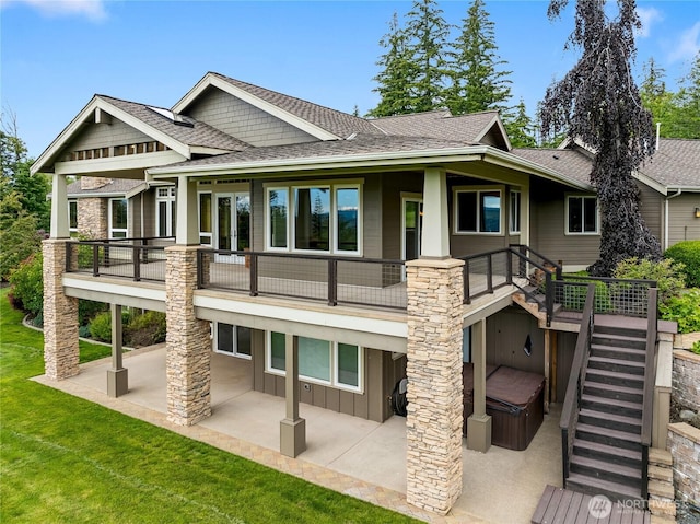 rear view of property with board and batten siding, a patio, a shingled roof, and a lawn