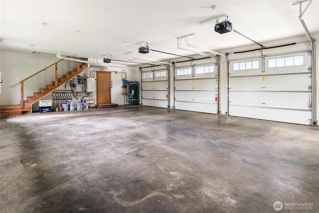 garage with gas water heater and a garage door opener