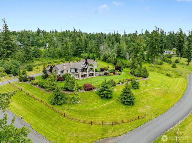 bird's eye view with a wooded view