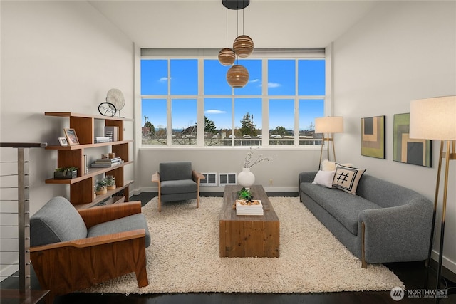 living room with plenty of natural light, visible vents, and baseboards