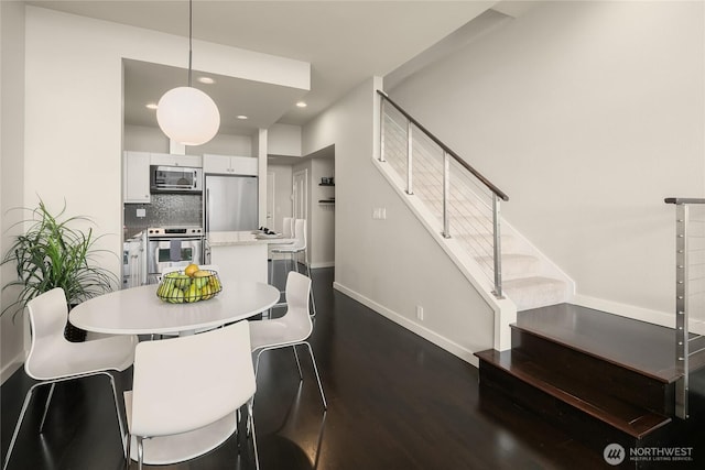 dining space featuring stairway, recessed lighting, baseboards, and dark wood-style flooring