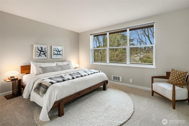 carpeted bedroom with baseboards and visible vents