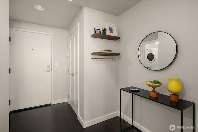 interior space with dark wood finished floors, washer / dryer, recessed lighting, and baseboards