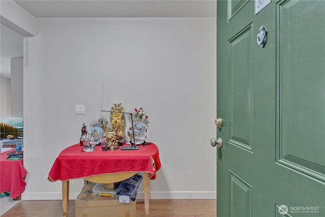 entryway with wood finished floors and baseboards