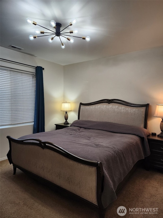 bedroom with carpet, visible vents, and a notable chandelier