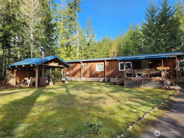 rear view of property featuring crawl space and a yard