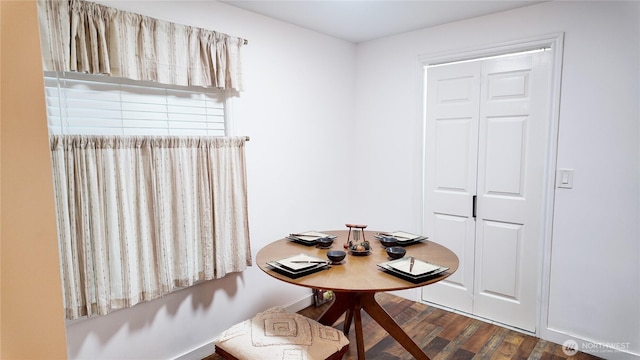 dining space with wood finished floors