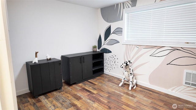 interior space featuring wood finished floors and baseboards