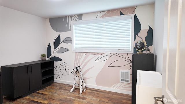 interior space with baseboards and wood finished floors