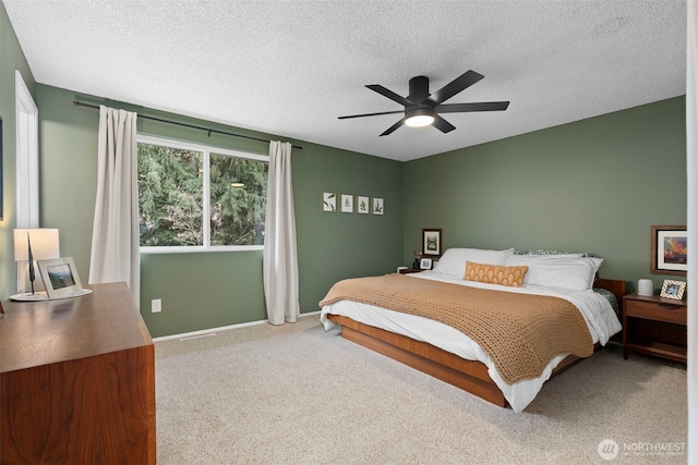 bedroom with a textured ceiling, ceiling fan, and carpet flooring