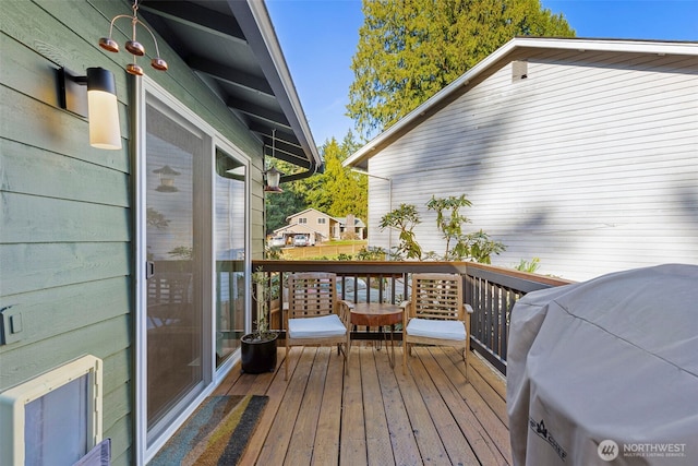 wooden terrace featuring grilling area