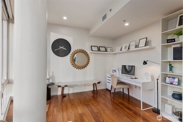 office space with recessed lighting, visible vents, baseboards, and wood finished floors