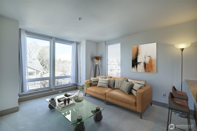 carpeted living room featuring baseboards