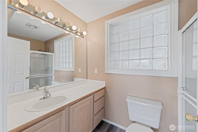 full bath featuring a shower stall, toilet, and vanity