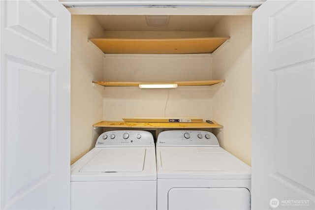 clothes washing area with laundry area and washer and clothes dryer