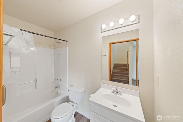 bathroom with toilet,  shower combination, and vanity