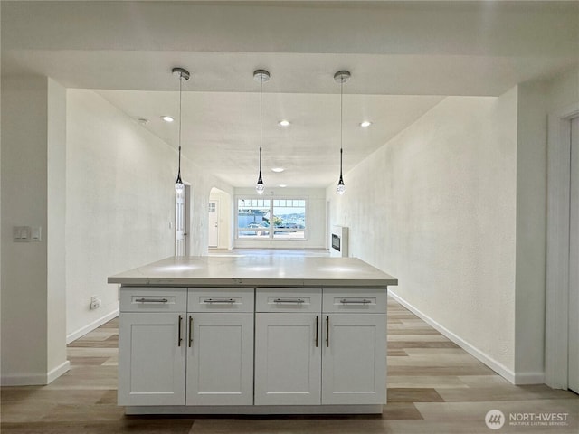 kitchen with light countertops, light wood-type flooring, and baseboards