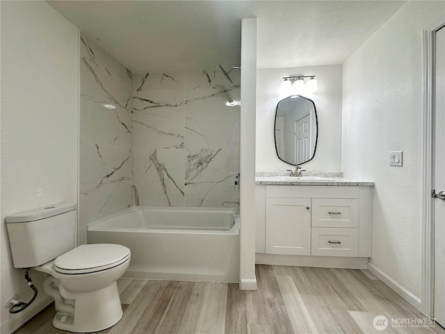 bathroom featuring shower / tub combination, vanity, toilet, and wood finished floors