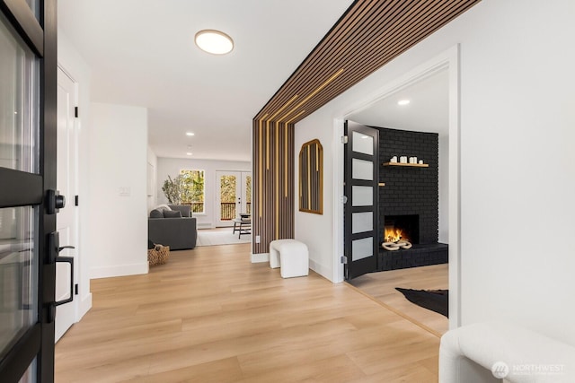 hall with recessed lighting, light wood-style flooring, and baseboards