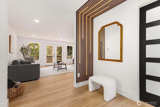 corridor with light wood finished floors, baseboards, french doors, and recessed lighting