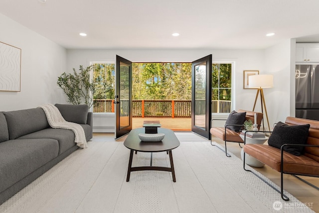 living room featuring light wood finished floors, french doors, and recessed lighting