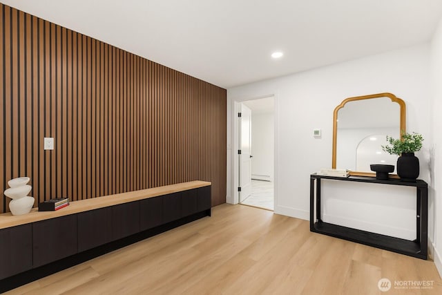 interior space with light wood finished floors, baseboards, baseboard heating, and recessed lighting