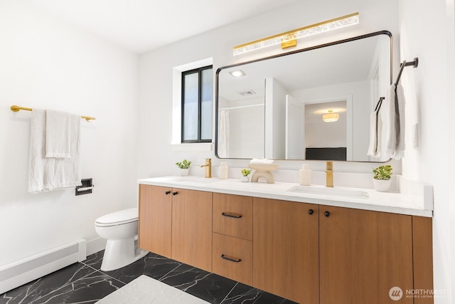 full bathroom with double vanity, marble finish floor, a baseboard radiator, and a sink