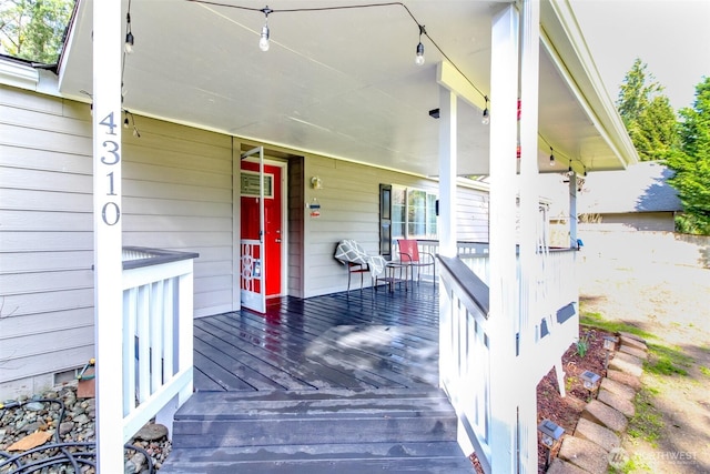 view of exterior entry featuring covered porch