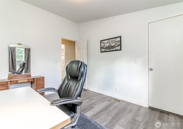 office featuring visible vents, wood finished floors, and baseboards