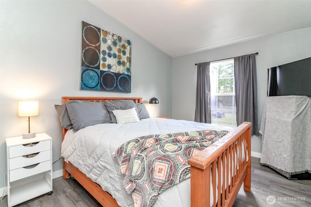 bedroom featuring baseboards and wood finished floors