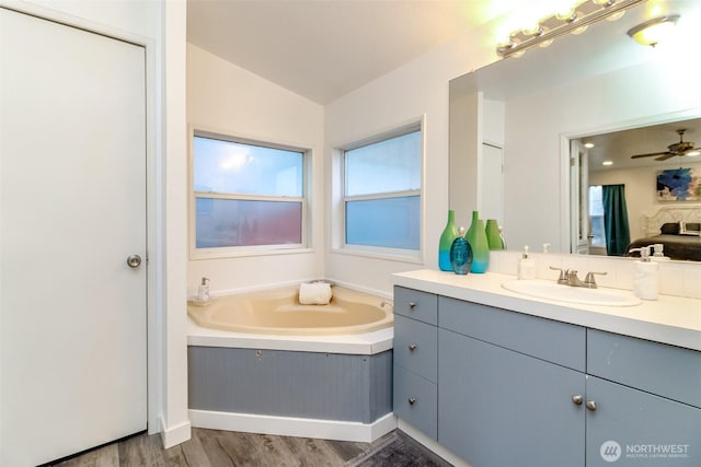 bathroom featuring vanity, a garden tub, wood finished floors, and ceiling fan