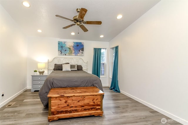 bedroom featuring recessed lighting, baseboards, wood finished floors, and vaulted ceiling