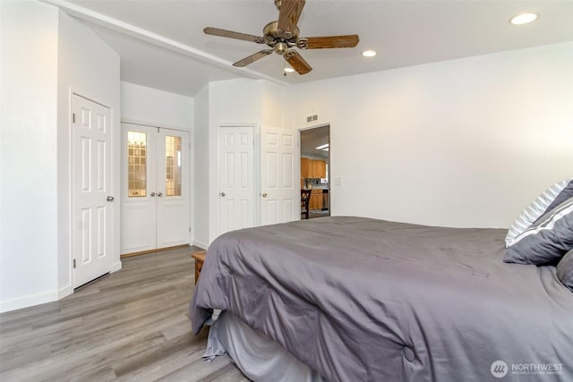 bedroom featuring visible vents, a ceiling fan, wood finished floors, recessed lighting, and baseboards