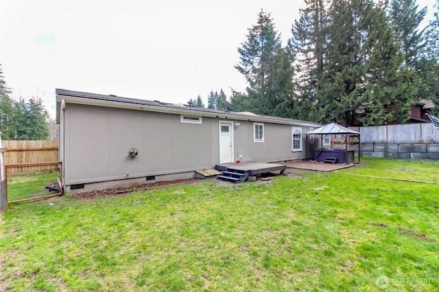 rear view of house featuring crawl space, a yard, a deck, and fence