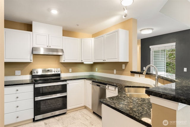 kitchen with marble finish floor, stainless steel appliances, under cabinet range hood, white cabinetry, and a sink