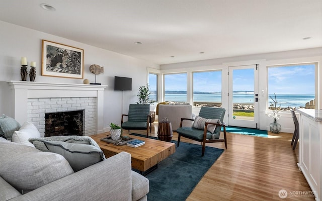 living room with recessed lighting, wood finished floors, and a fireplace