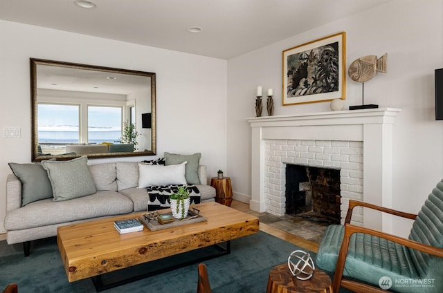 living area featuring recessed lighting and a brick fireplace