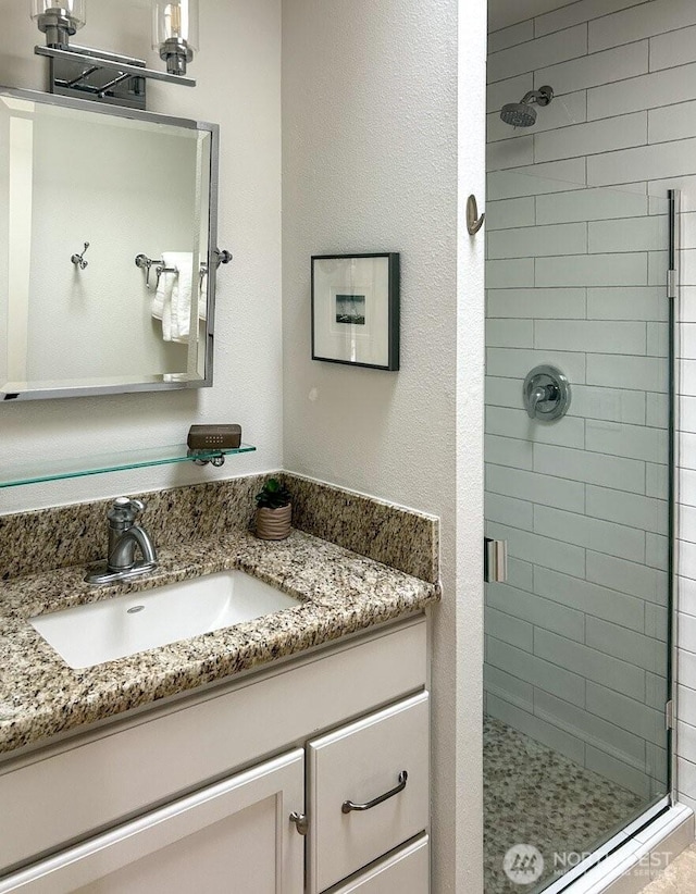 bathroom with vanity and a stall shower